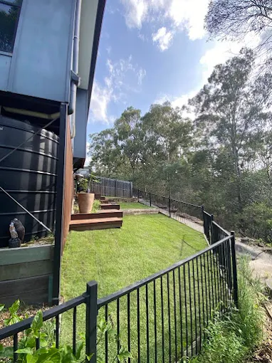 Fresh lawn installed on a sloped residential property